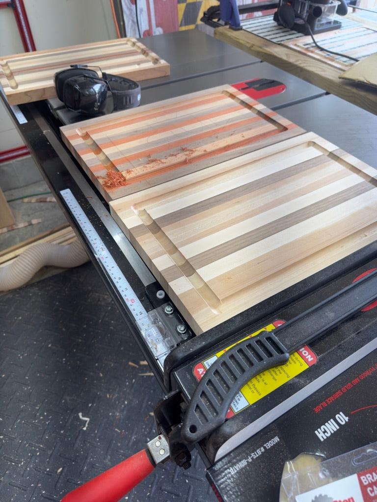 Wooden cutting board being cut on a table saw with a visible brand name.