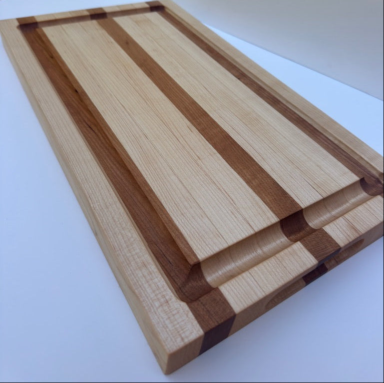 Wooden cutting board with a striped pattern on a white surface