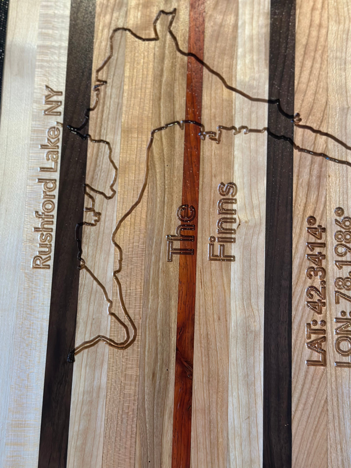 Custom engraved hardwood cutting board handcrafted from walnut, padauk, cherry and maple
