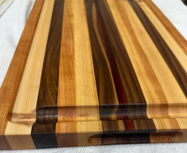 Wooden cutting board with striped pattern on a white background