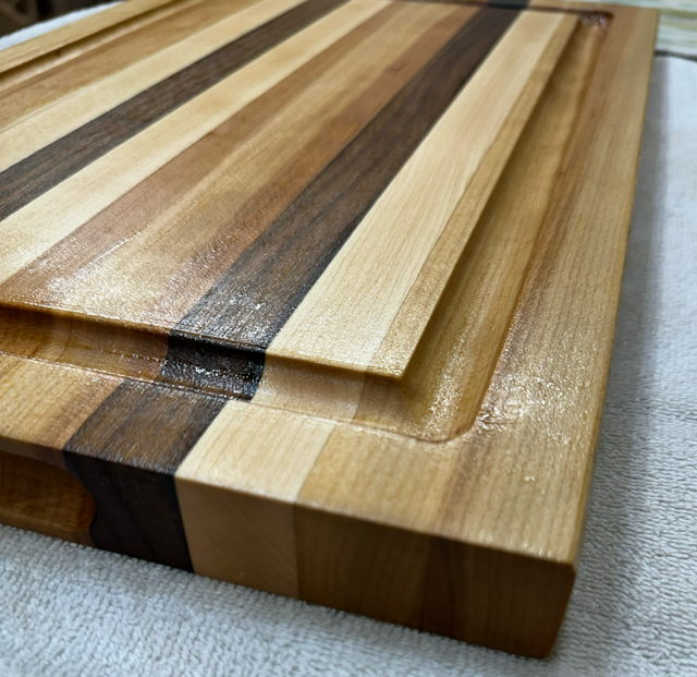 Wooden cutting board with striped pattern on a light background