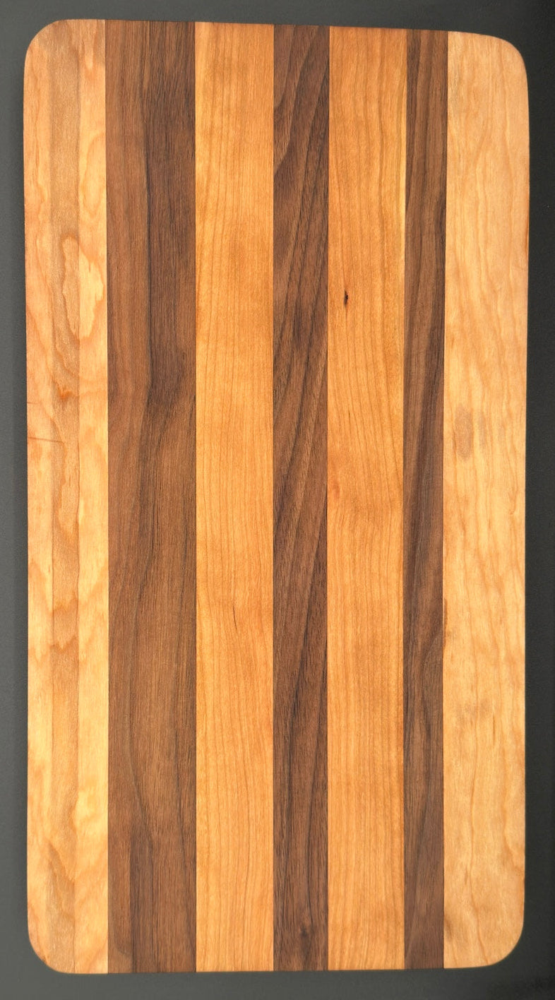 Handcrafted walnut cherry and maple charcuterie board by All In Fine Wood