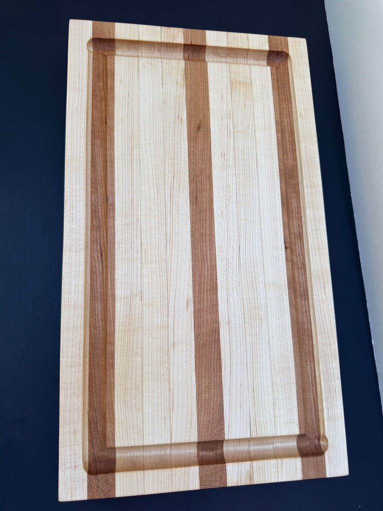 Wooden cutting board with a striped pattern on a dark background