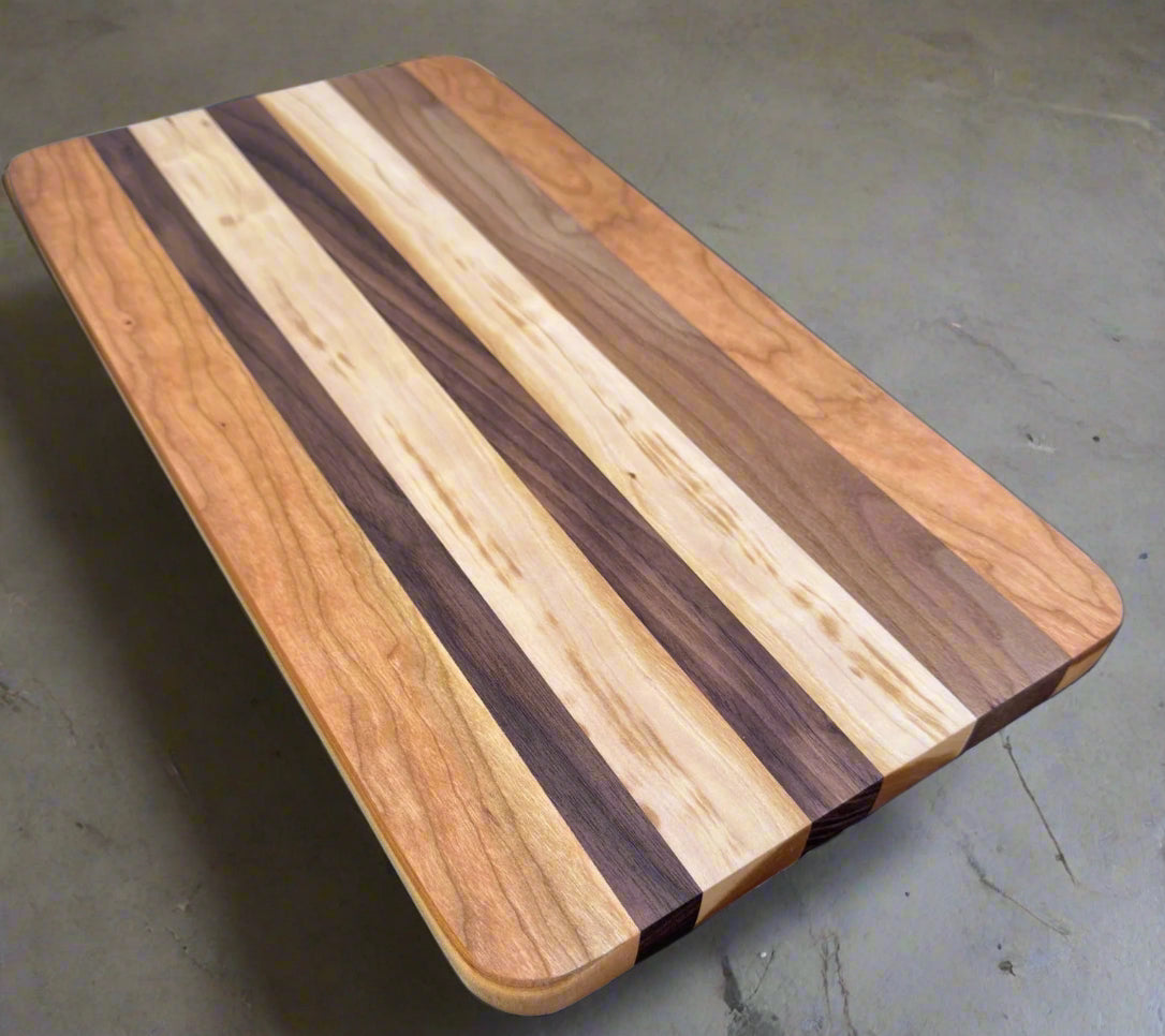 Wooden cutting board with striped pattern on a blue surface