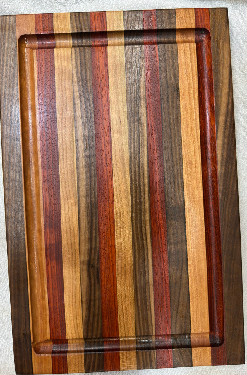 Wooden cutting board with multicolored stripes on a white background