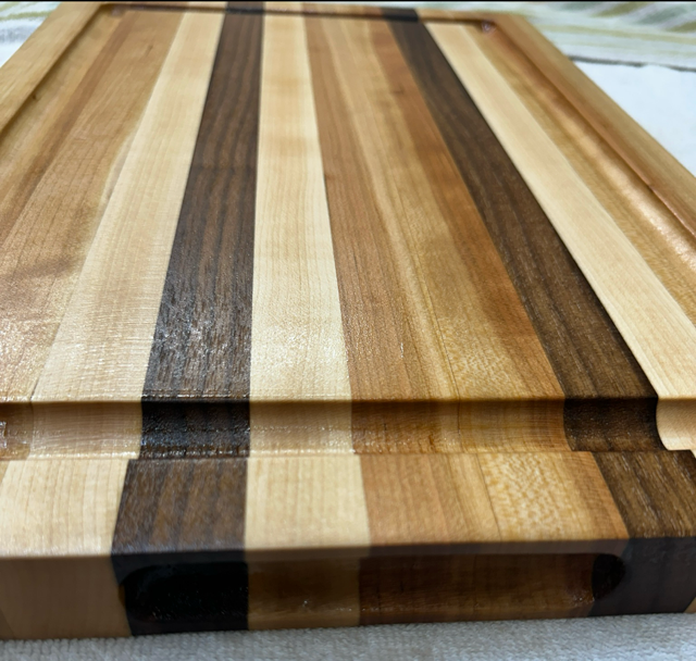 Wooden cutting board with striped pattern on a neutral background