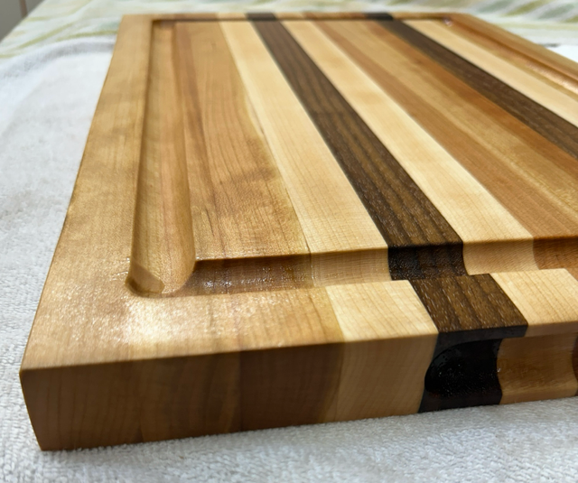 Wooden cutting board with a striped pattern on a light background