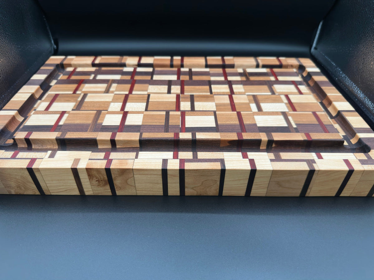 Low angle view showing the 1 3/4 inch thickness and juice groove of the Pitmaster Plaid board
