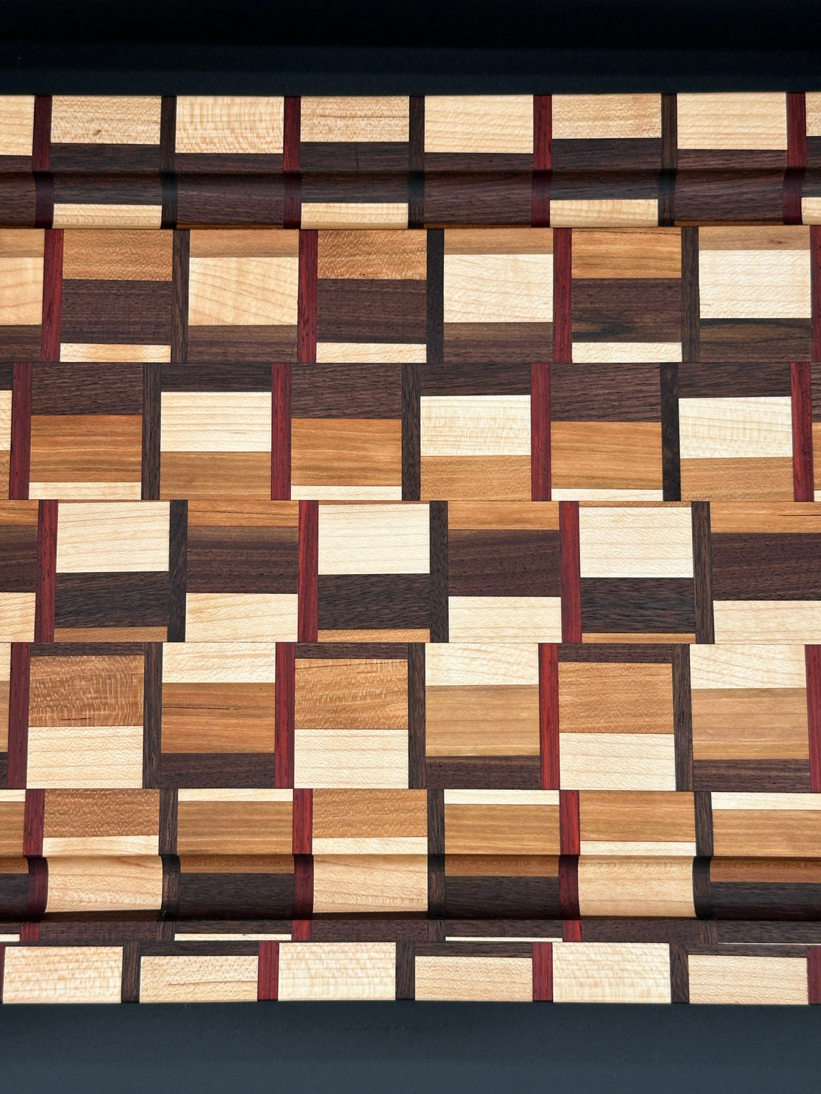 Close-up detail of walnut cherry maple and padauk in the Heritage Weave board